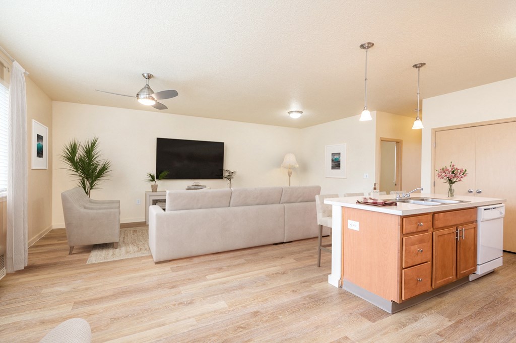 a living room with a couch and a kitchen