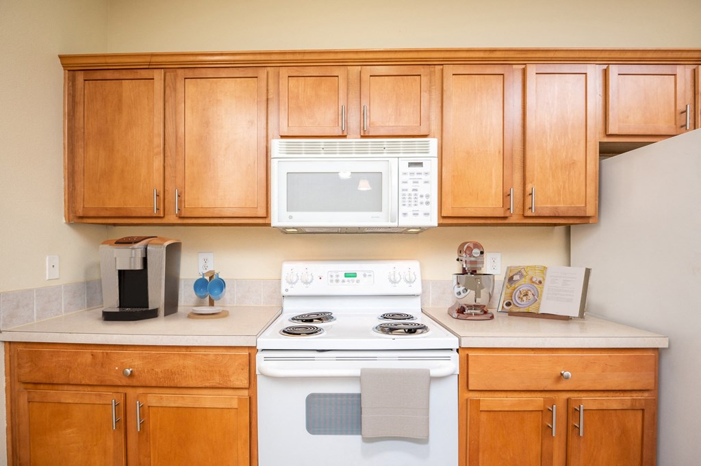 a kitchen with a stove microwave and cabinets