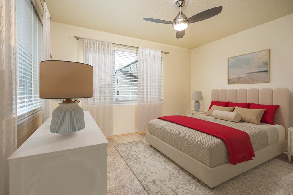 a bedroom with a bed and a ceiling fan