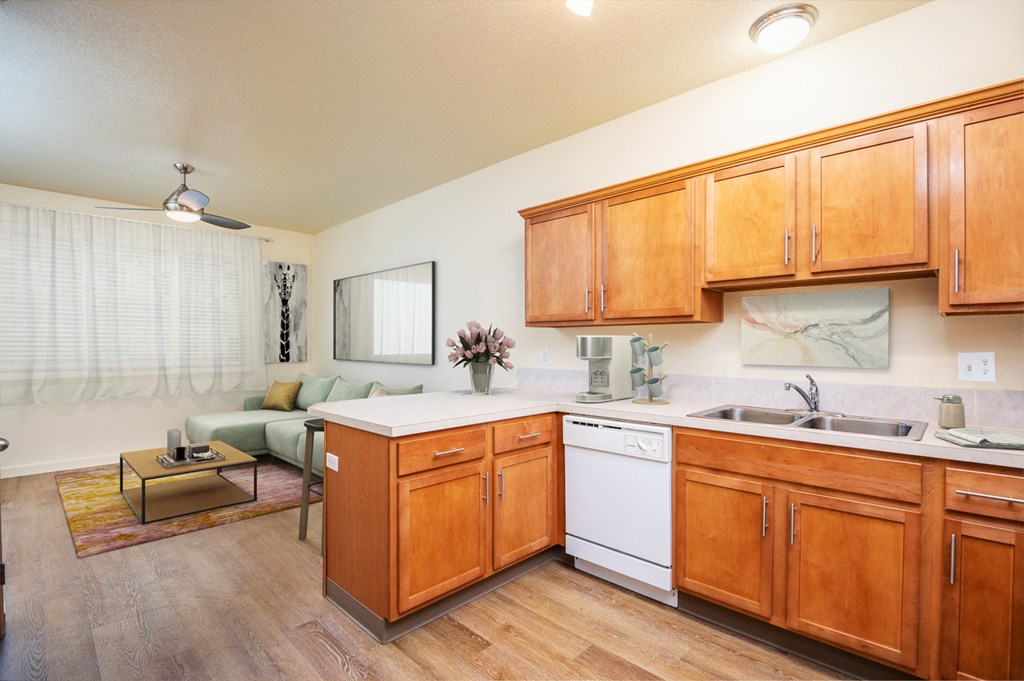 a kitchen and living room with wooden cabinets and white appliances