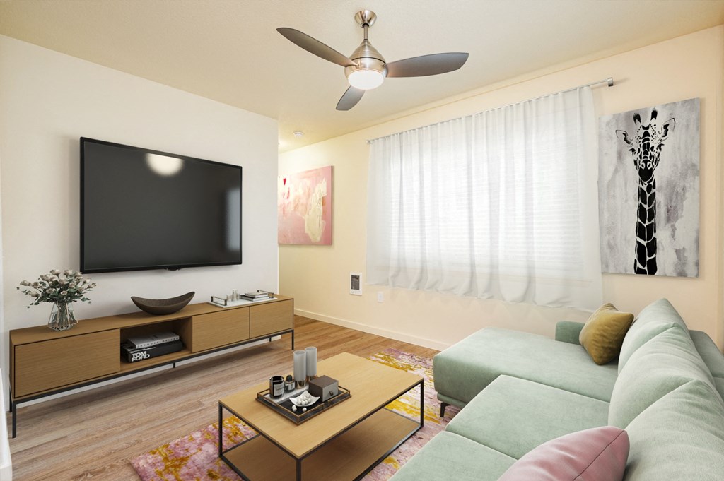 a living room with a couch and a television on the wall