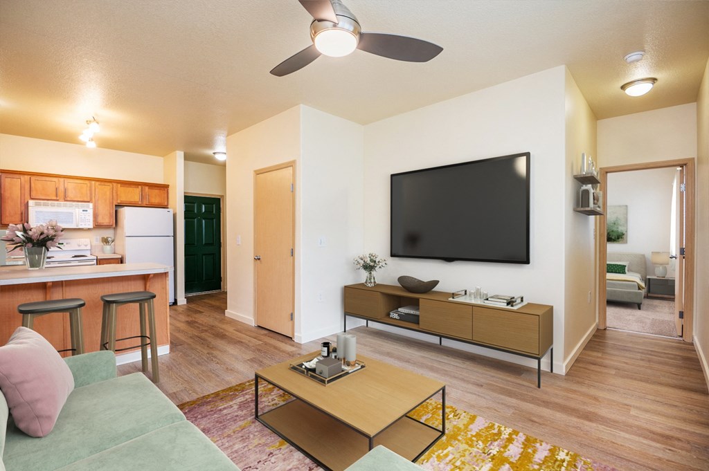 the view of a living room and a kitchen with a tv
