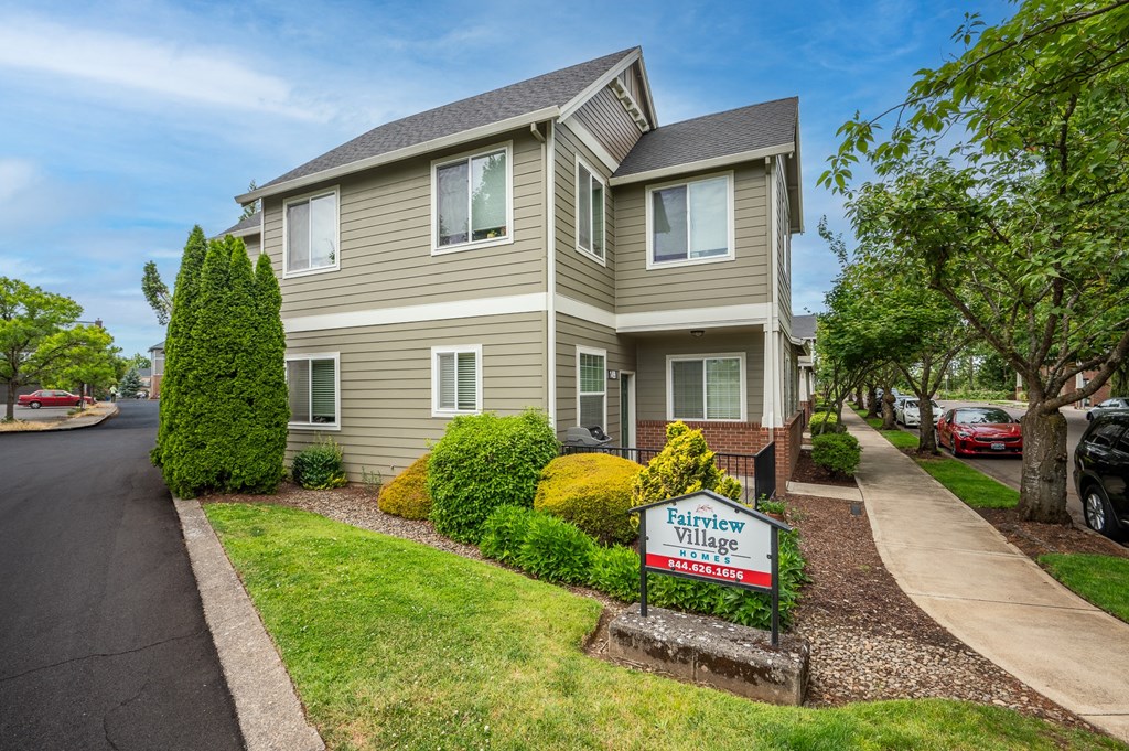 a house with a for sale sign in front of it