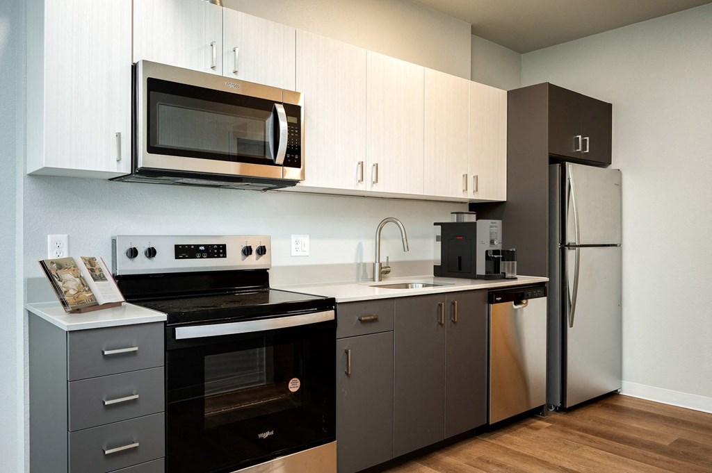A modern kitchen with a black oven and microwave.