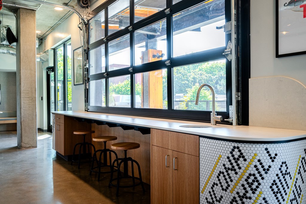 a counter and stools in front of a window