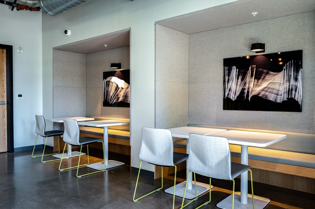 flock13 resident lounge study seating with tables and chairs and a painting on the wall