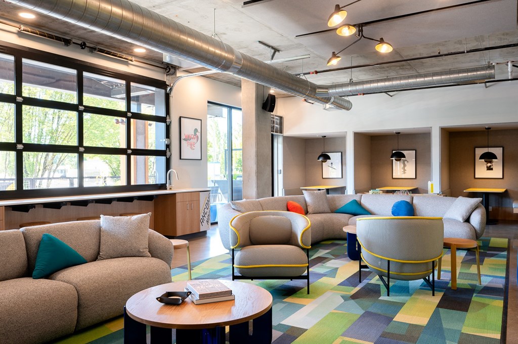 a lounge room with couches and chairs and a table