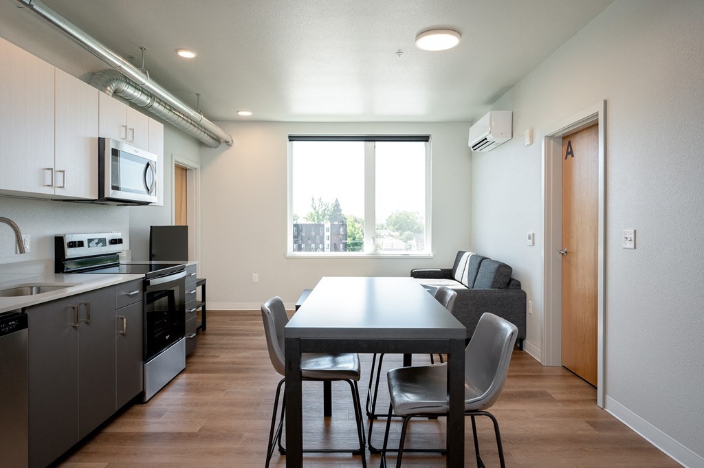 a kitchen and dining room with a table and chairs