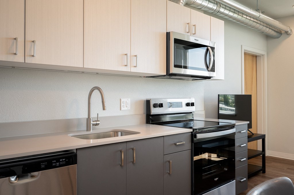 an empty kitchen with a sink and a microwave