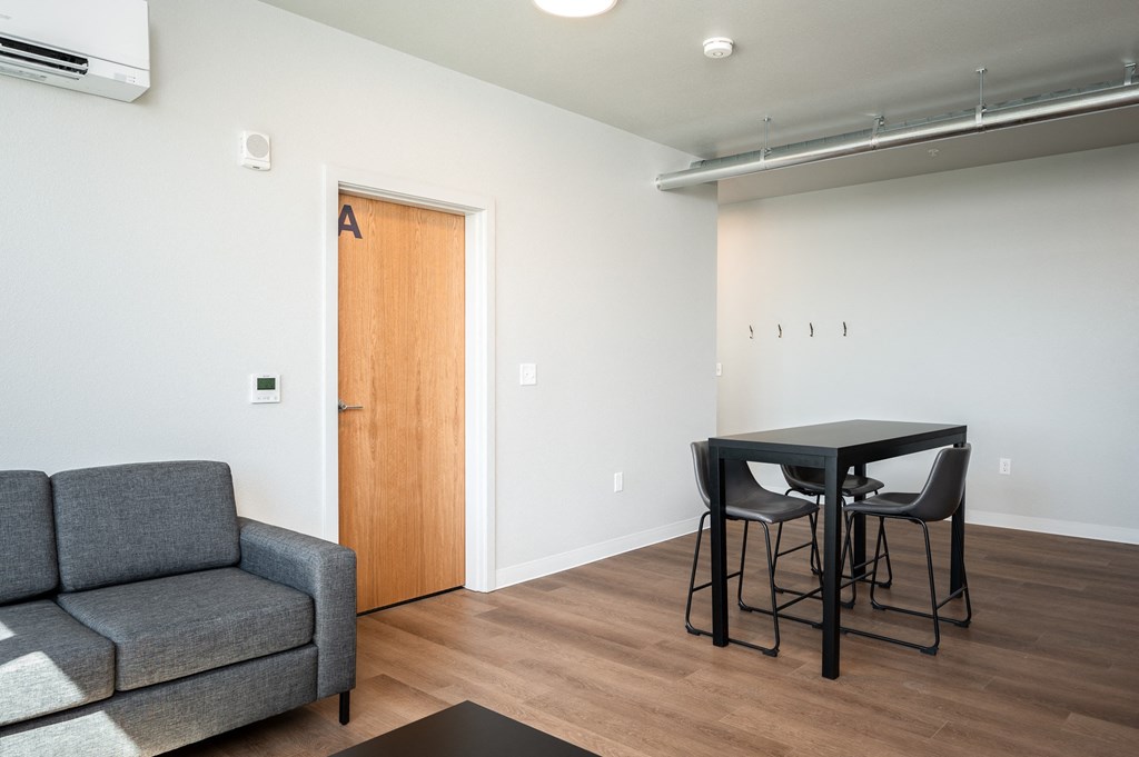 a living room with a couch and a table and a chair