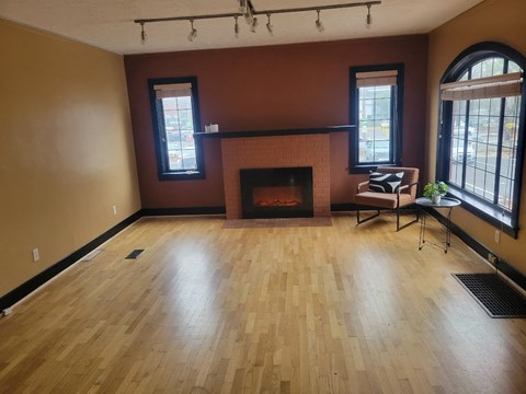 A room with a fireplace and a chair.