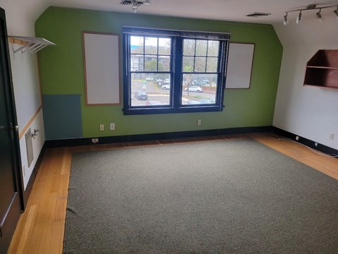 A room with a green wall and a window.