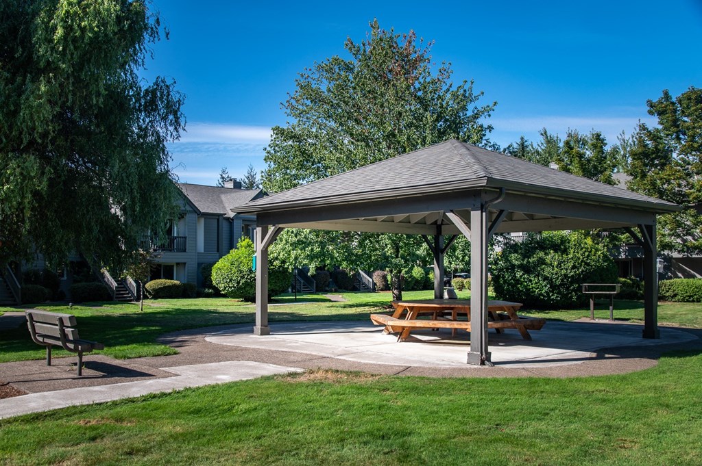 a pavilion with a picnic table in a park
