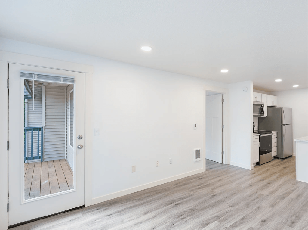 a bedroom with a medium sized bed and a mirror on the wall