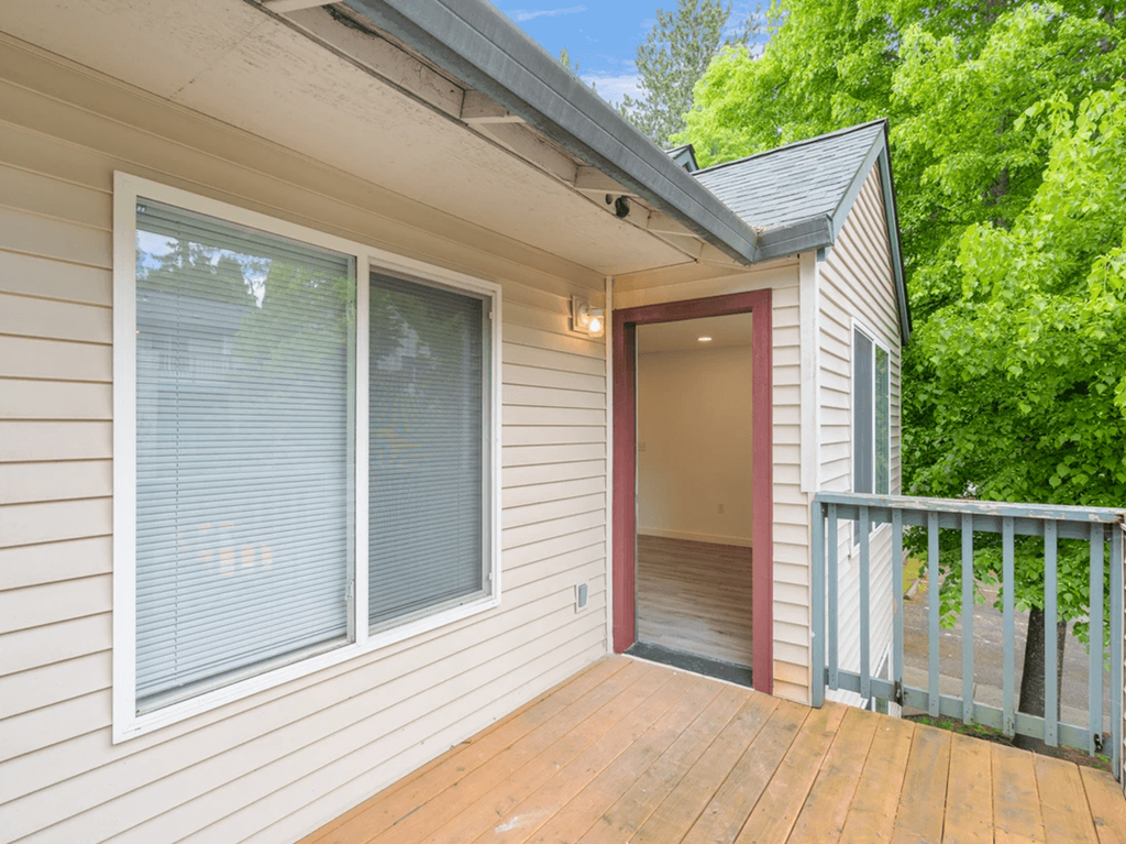 a balcony with a door that leads to a hallway