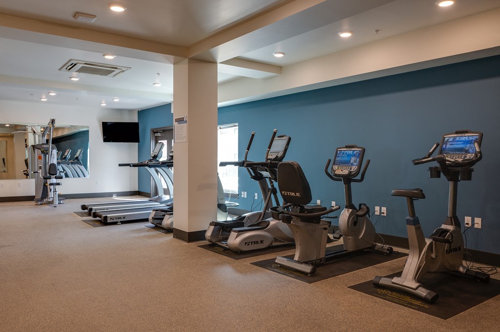 a gym with treadmills and other exercise equipment in a building