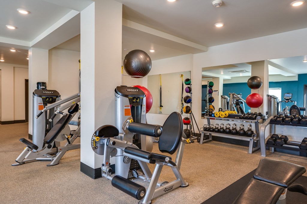 a gym with weights and other exercise equipment and a bowling ball