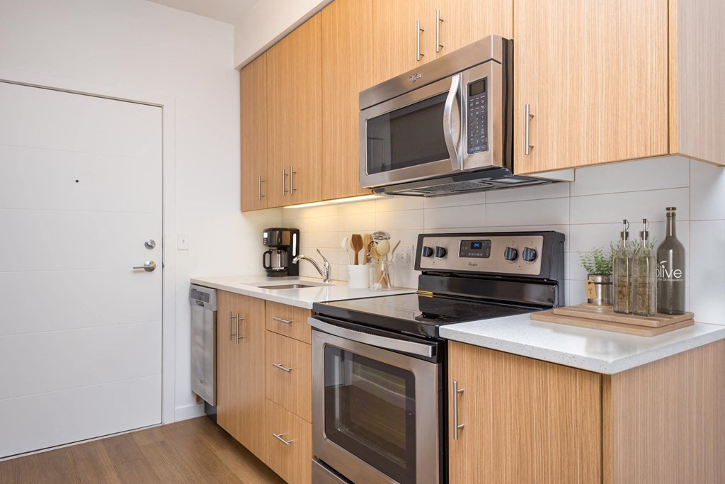 a kitchen with stainless steel appliances and wooden cabinets