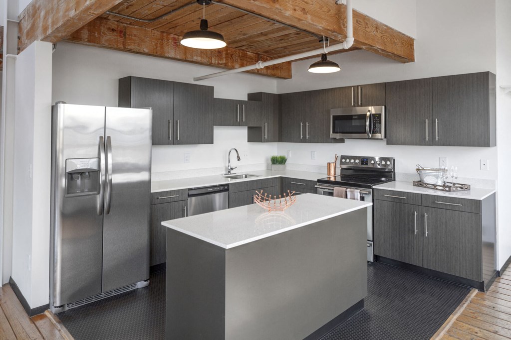 a kitchen with stainless steel appliances and a large island