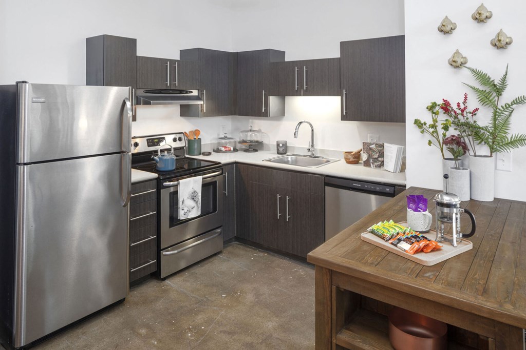 a kitchen with stainless steel appliances and a wooden table