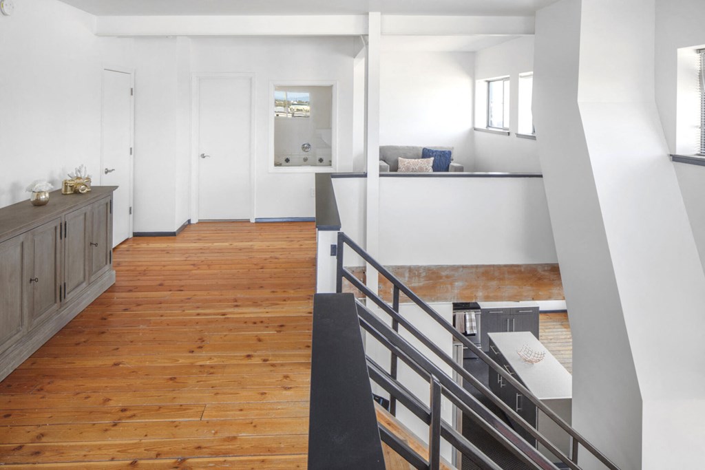 a view of a living room from the top of a staircase