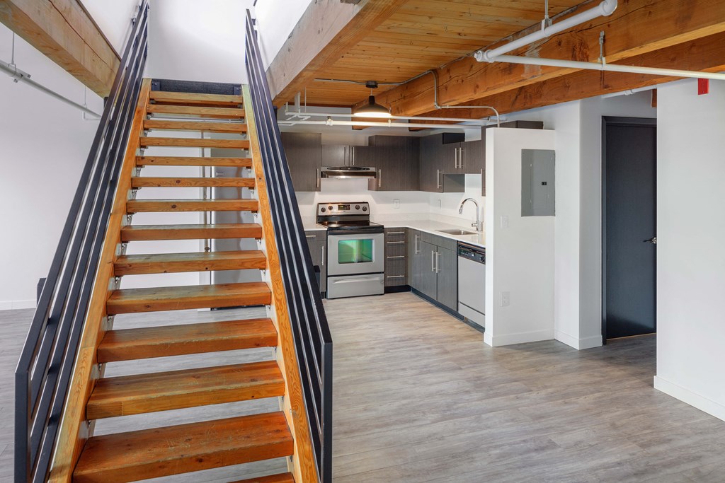 a staircase leading up to a kitchen in a loft