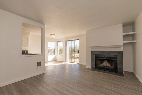 a living room with a fireplace and a balcony