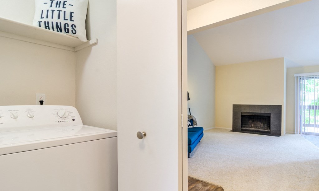 a laundry room with a washer and dryer and a fireplace