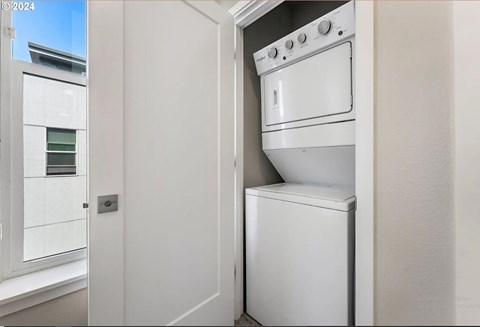 A white oven is built into a kitchen wall.
