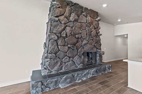a large stone fireplace in the center of a living room
