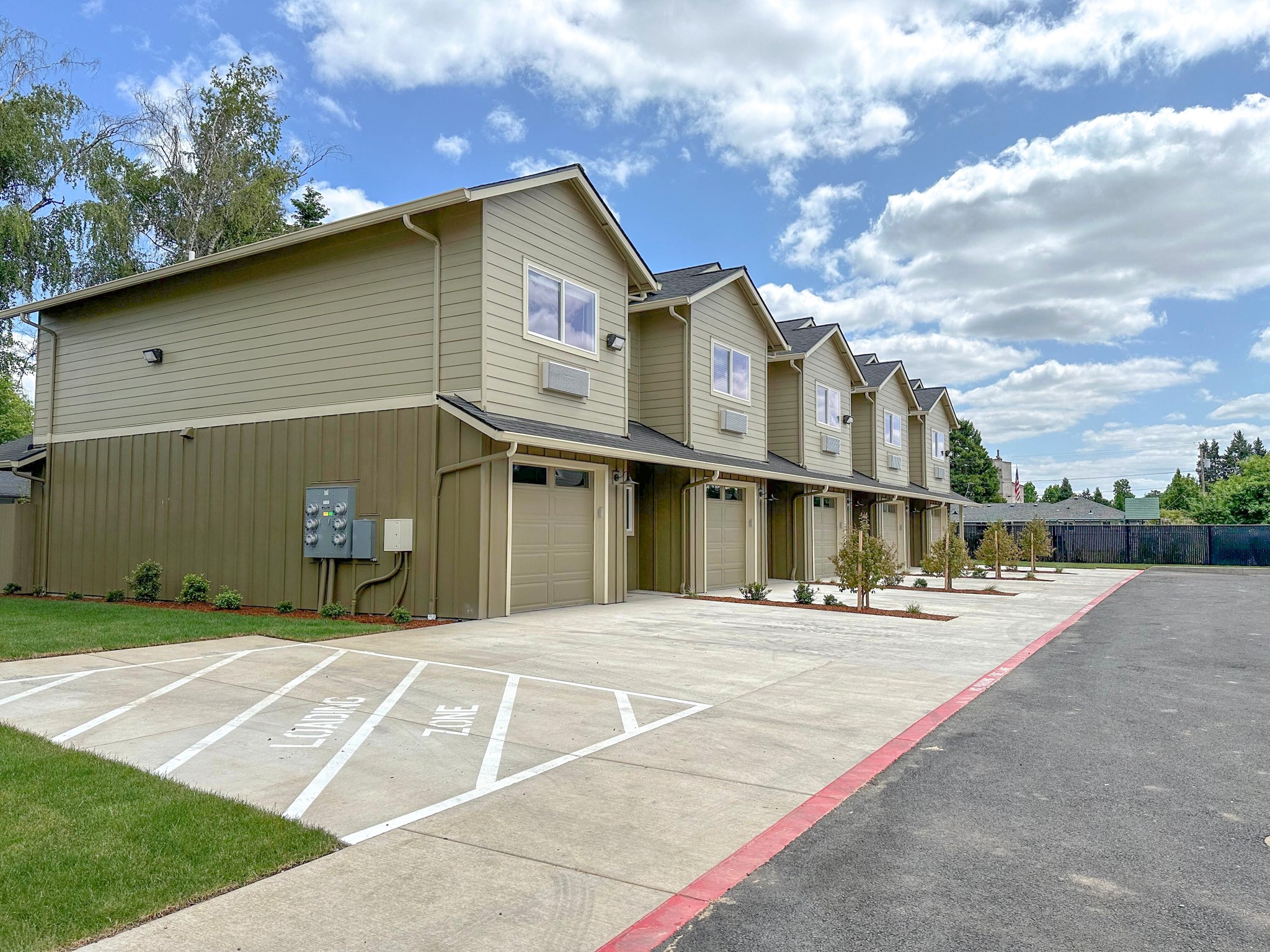 a row of houses with a parking lot
