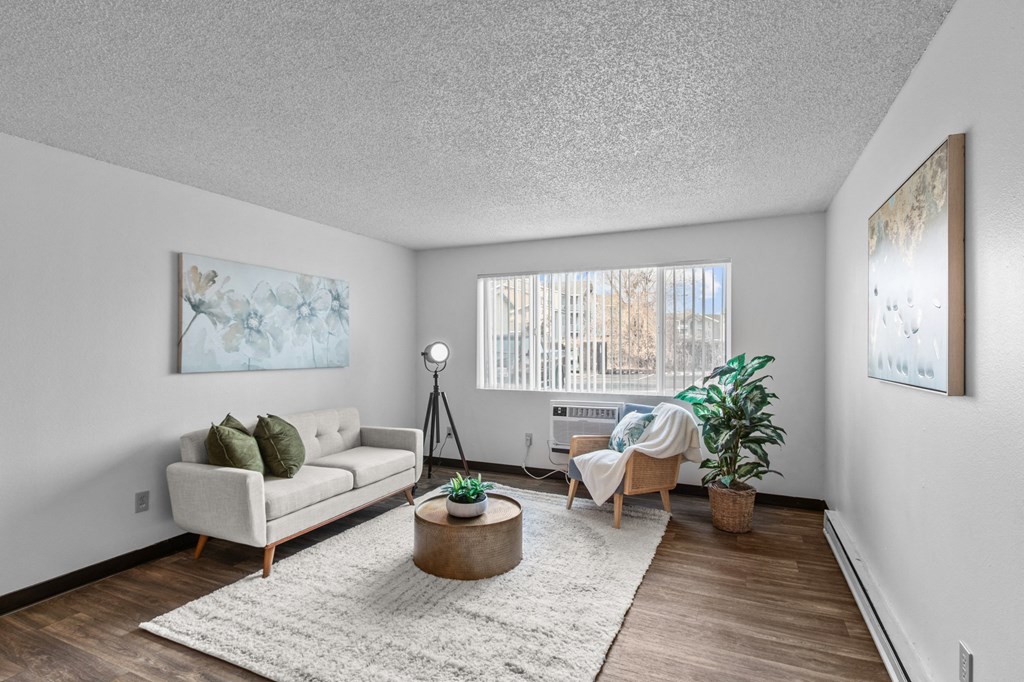 the living room of an apartment with a couch and a chair