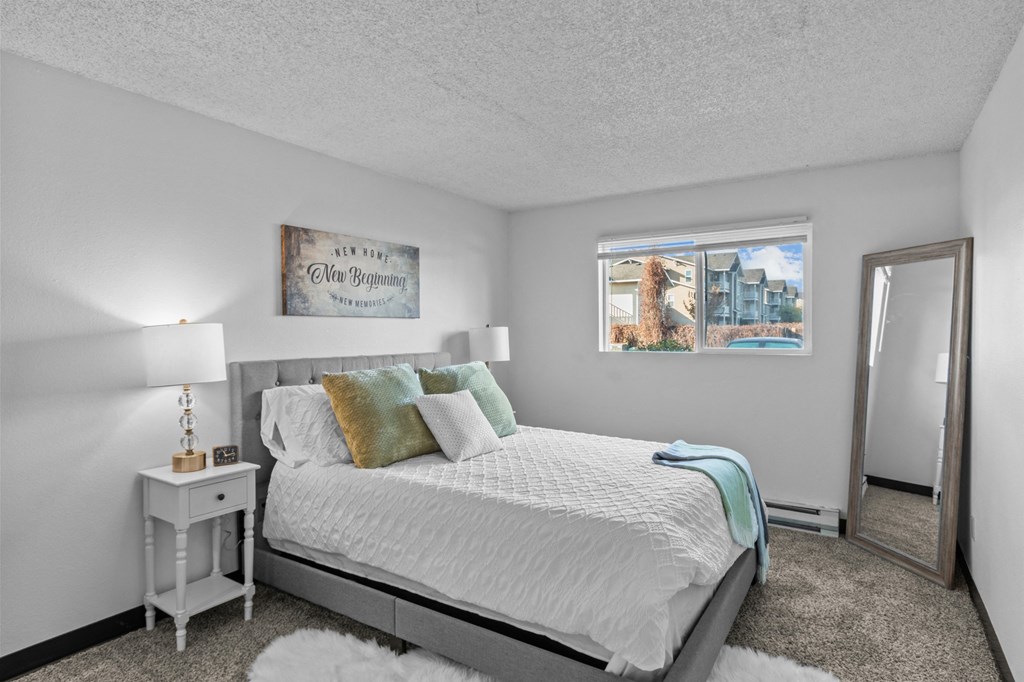 a bedroom with a bed and a mirror