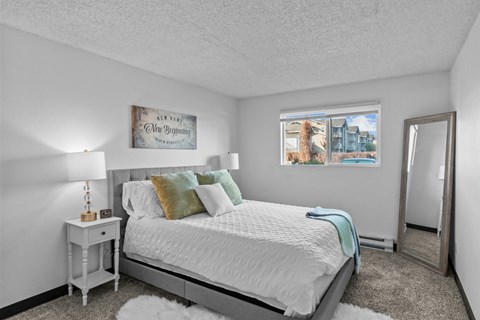 a bedroom with a bed and a mirror