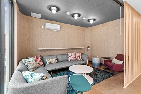 A living room with a grey couch and a blue chair.