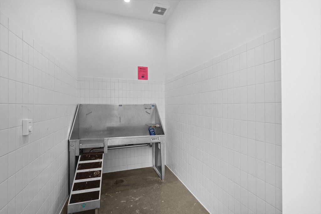 a workbench in a white room with a red sign on the wall