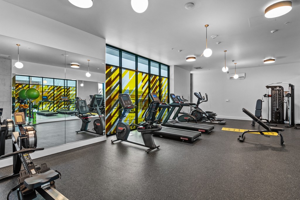 a gym with treadmills and other exercise equipment