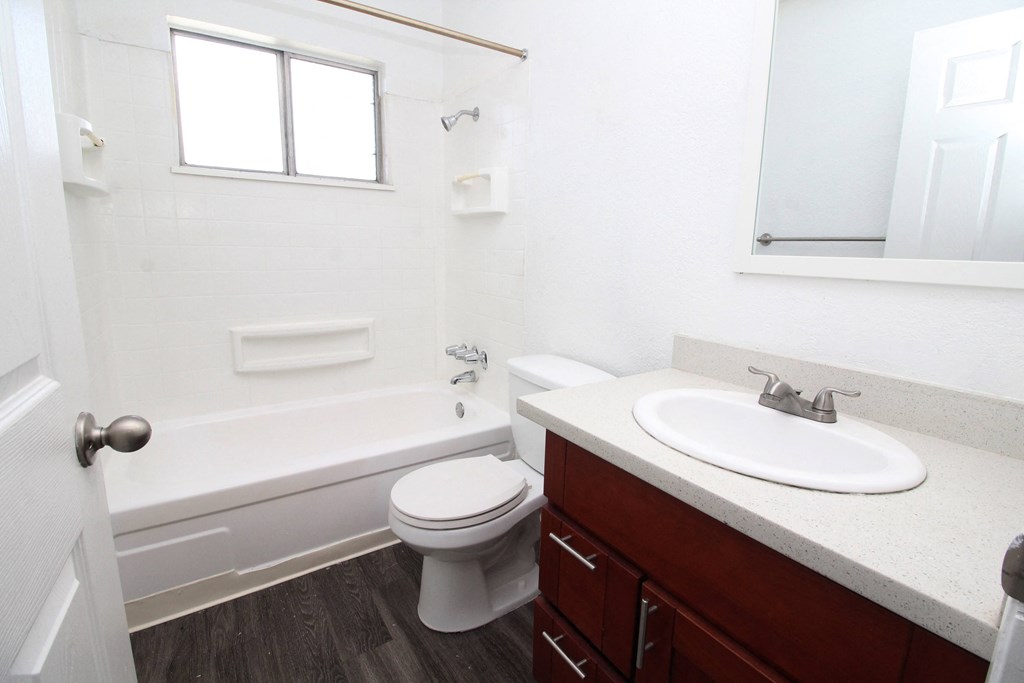 an empty bathroom with a sink toilet and bath tub