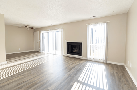 A living room with a fireplace and sliding glass doors.