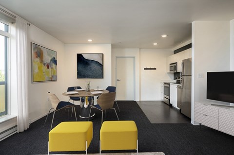 A modern kitchen with a dining table and chairs.