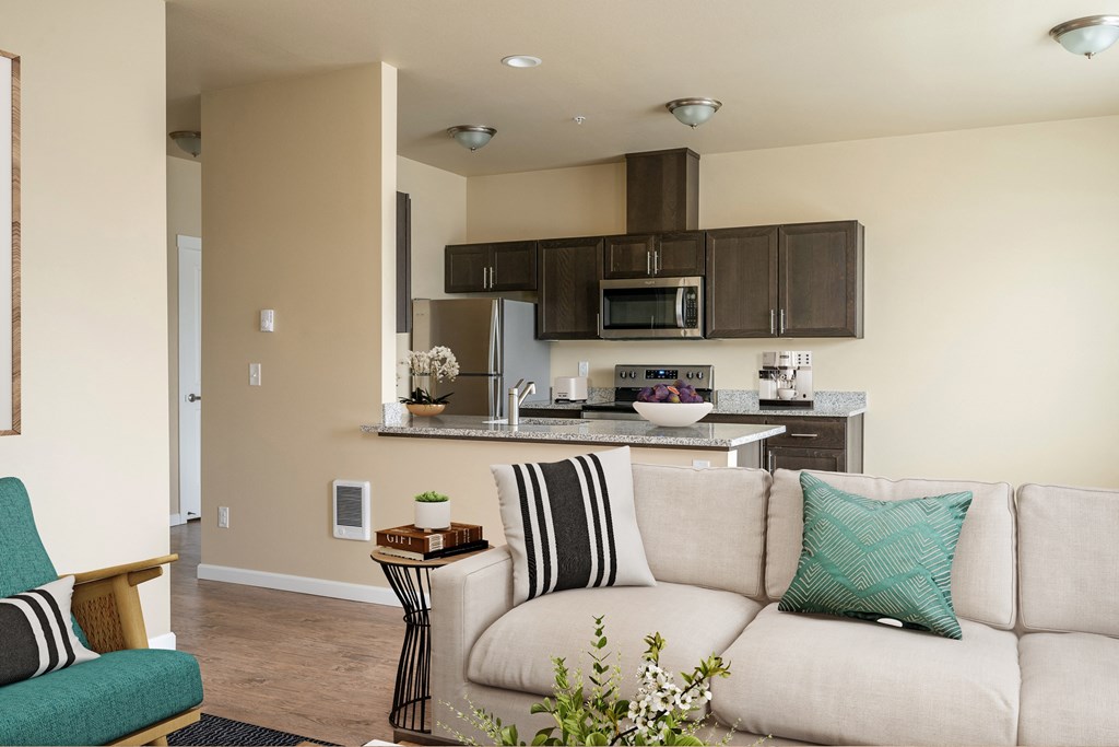 a living room with a couch and a kitchen