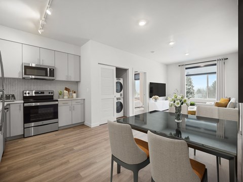 a kitchen and living room with a table and chairs