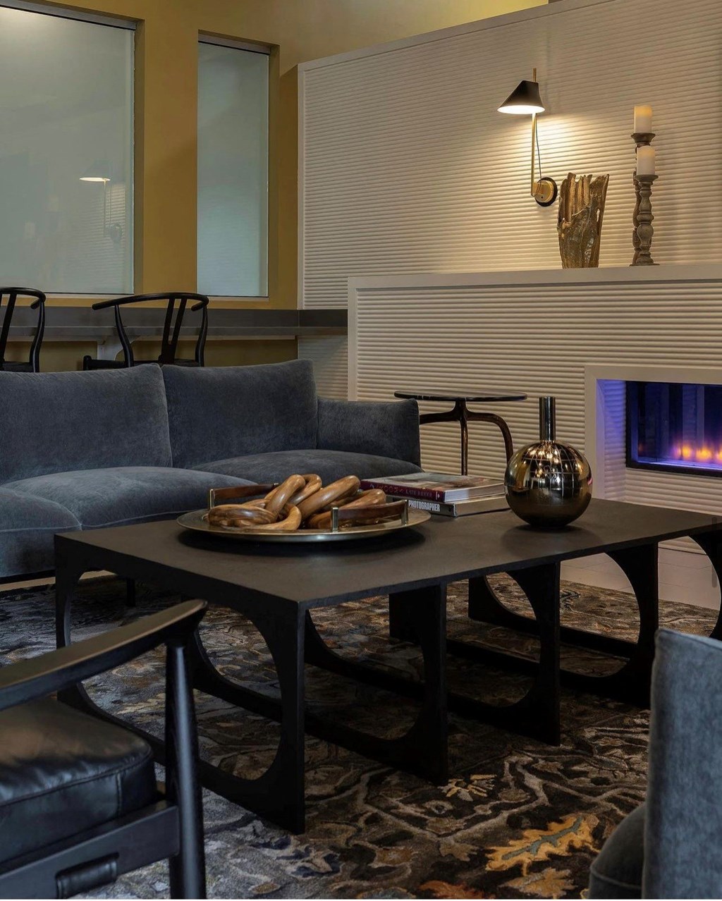 a living room with couches a table and a fireplace