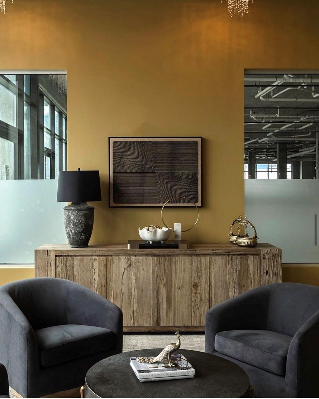 a living room with two chairs and a table and a wooden cabinet