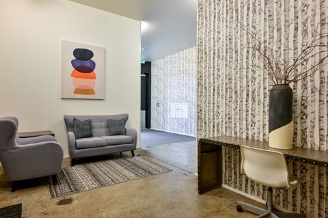 a living room with two couches and a desk with a chair