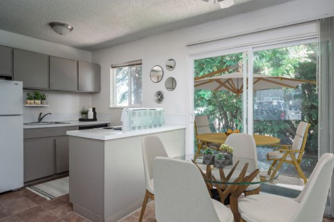 a kitchen and dining room with a table and chairs