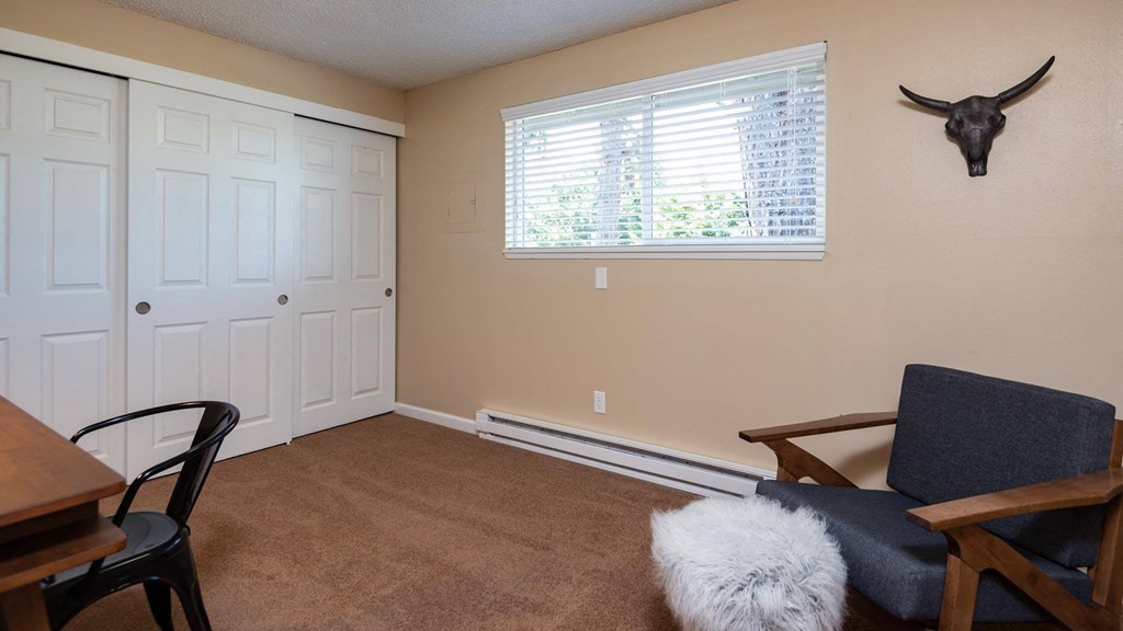 a landing with a window and a bulls head on the wall