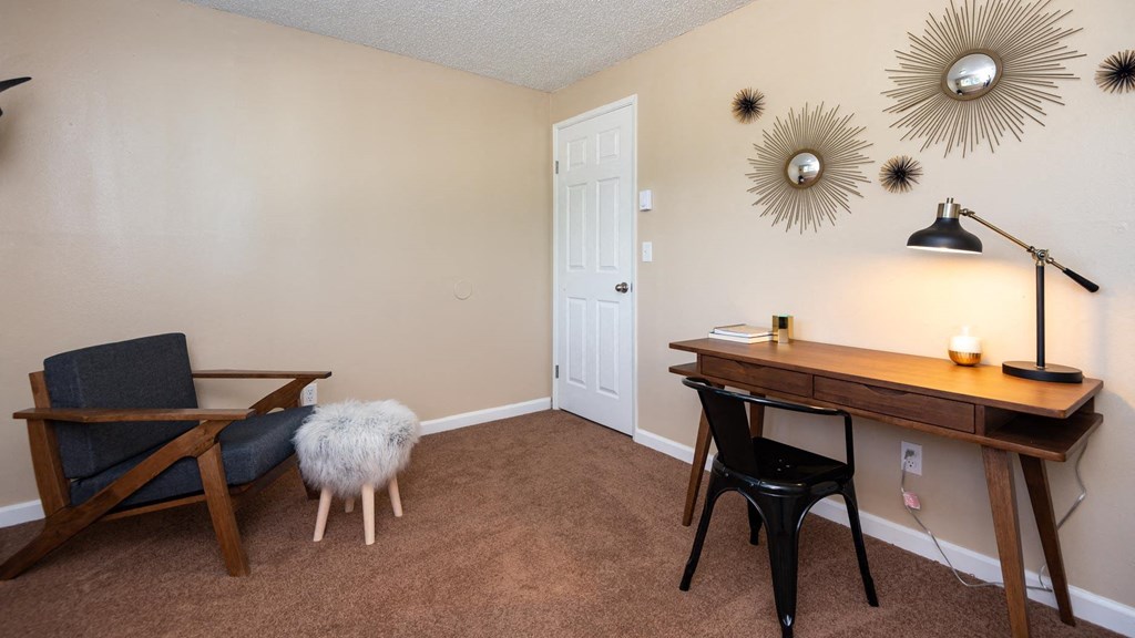 a home office with a desk and a chair