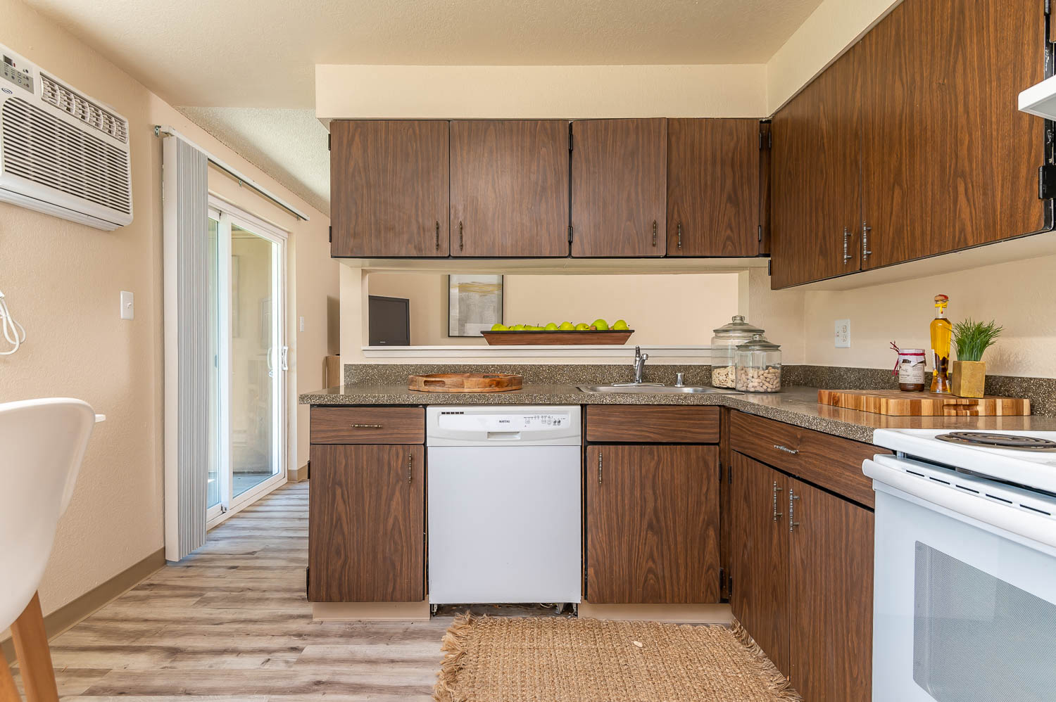 Model Kitchen with wood cabinetry and white appliances