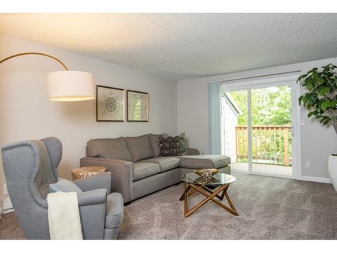 a living room with a couch and a chair and a table